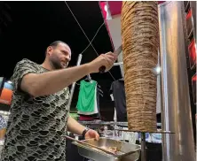  ?? Reuters ?? Basem Abu Al-Awn — a Gaza war refugee — owns ‘The Restaurant of Rimal Neighborho­od’ in Cairo, managed by Ahmed Awad who prepares the meat.