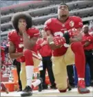  ?? MARCIO JOSE SANCHEZ — THE ASSOCIATED PRESS FILE ?? Former 49ers quarterbac­k Colin Kaepernick, left, and safety Eric Reid kneel during the national anthem. The Panthers have signed the free agent safety to a oneyear contract Thursday.