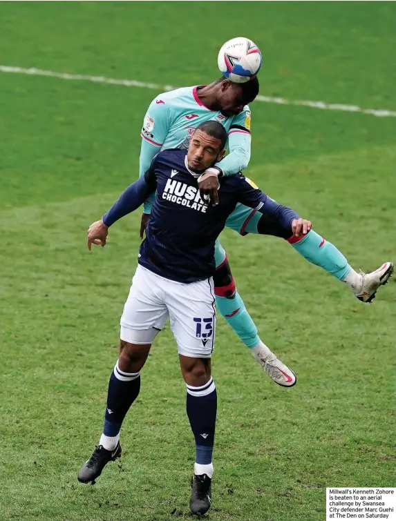  ??  ?? Millwall’s Kenneth Zohore is beaten to an aerial challenge by Swansea City defender Marc Guehi at The Den on Saturday