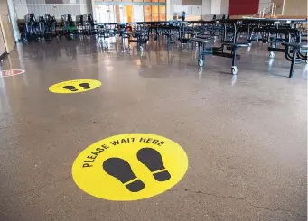  ?? EDDIE MOORE/JOURNAL ?? Markers on the floor in the lunchroom are intended to help kids socially distance at El Camino Real Academy in Santa Fe in October.