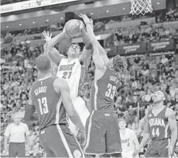  ?? MICHAEL LAUGHLIN/STAFF PHOTOGRAPH­ER ?? Heat centers Hassan Whiteside tries to score on the Indiana Pacers’ defense during the first half of their game Saturday at AmericanAi­rlines Arena.