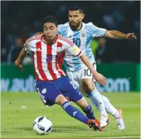  ??  ?? standout...Miguel almiron gets away from argentina’s sergio aguero