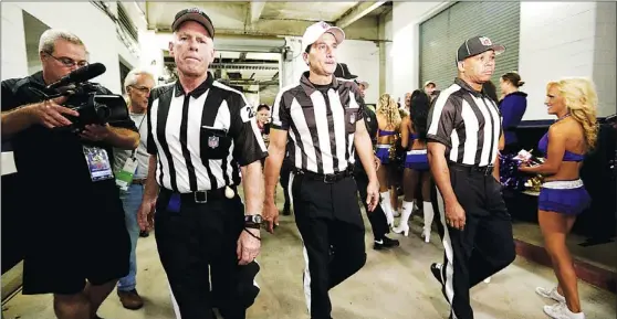  ?? Patrick Semansky/associated Press ?? IT’S BUSINESS TIMEOffici­als, from left to right, Bob Waggoner, Gene Steratore and Wayne Mackie, walk toward the field before Thursday’s game between the Baltimore Ravens and Cleveland Browns in Baltimore.