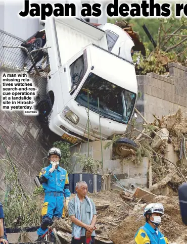  ?? REUTERS ?? A man with missing relatives watches search-and-rescue operations at a landslide site in Hiroshima yesterday.