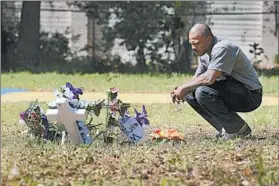  ?? CHUCK BURTON/AP ?? Terence Wright pays his respects Thursday at the scene where Walter Scott was fatally shot by police Officer Michael Slager in North Charleston, S.C., last weekend.