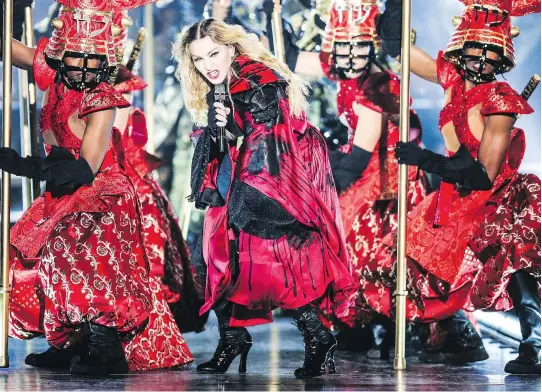  ?? RICH FURY/THE ASSOCIATED PRESS ?? Madonna, seen in 2015 during her Rebel Heart Tour, made ambitious costume changes, revolution­ary lighting and complicate­d dance routines her signature.