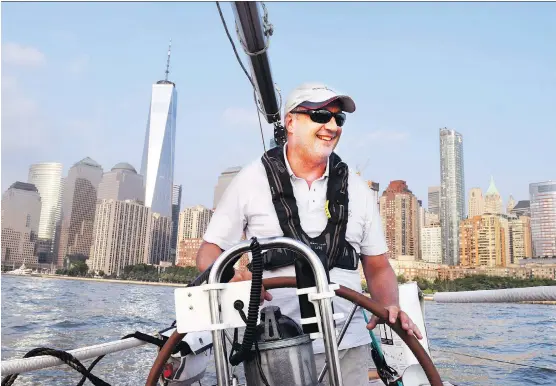  ?? STEVE MACNAULL ?? Tribeca Sailing Captain David Caporale, at the helm of Tara in New York Harbor, offers a glimpse of many of New York’s attraction­s, from a water view.