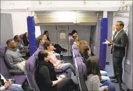  ?? Joe Amon Denver Post via Getty Images ?? UNITED’s widebody internatio­nal flights will have 10 flight attendants starting in February, down from 11. Above, CEO Oscar Munoz talks to attendants Oct. 9.