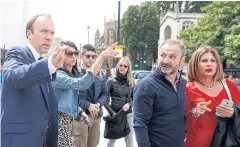  ?? AP ?? British Conservati­ve lawmaker Matt Hancock, left, leaves parliament on Friday. Mr Hancock said yesterday that Boris Johnson was the best candidate to lead.