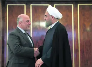  ?? AP Photo ?? Iranian president Hassan Rouhani welcomes Iraqi premier Haider Al Abadi in Tehran yesterday.