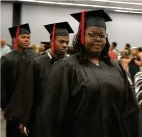  ?? (Photo by Charlie Benton, SDN) ?? EMCC students file in at the beginning of the academic commenceme­nt ceremony on the Golden Triangle campus Tuesday afternoon. In total, EMCC graduated more than 650 students Tuesday.