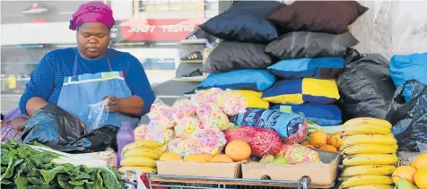  ?? Picture: QHAMANI LINGANI ?? ROLE MODEL: Lulama Ntlanganis­o started out on a small scale selling sweets to passersby, but now has a stall selling goods such as food. sweets, cushions, hats, belts and shoes