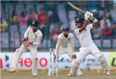  ?? AP ?? Captain Dinesh Chandimal, right, led Sri Lanka’s fightback in challengin­g smog-filled conditions on Day 3 in Delhi