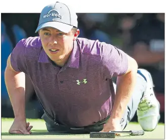  ??  ?? Matthew Fitzpatric­k gets down to action on the greens yesterday