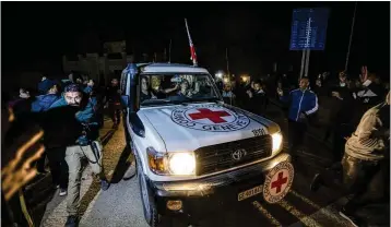  ?? FATIMA SHBAIR/AP ?? A Red Cross convoy carrying Israeli and foreign hostages heads to Egypt from the Gaza Strip on Sunday. A fourth hostage-palestinia­n prisoner exchange is expected today — the last day of the cease-fire.