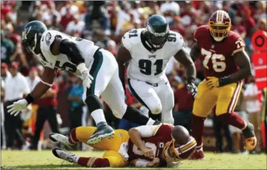 ?? THE ASSOCIATED PRESS — ALEX BRANDON ?? Eagles defensive tackle Fletcher Cox (91), pressuring Washington quarterbac­k Kirk Cousins in Week 1, will miss the Eagles trip to take on the Chargers Sunday with a calf injury.