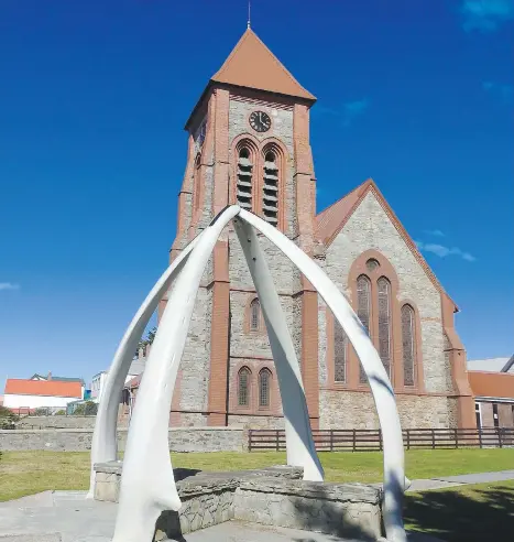  ?? PHOTOS: DAPHNE BRAMHAM ?? The Anglican cathedral graces the waterfront in the Falkland Islands capital of Stanley, It would not look out of place in an English country town — except for the arch that’s made from four jawbones from whales. That’s not surprising, since Stanley...