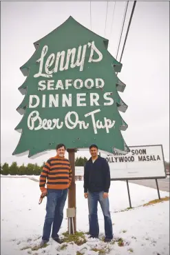  ?? STAFF PHOTO BY DARWIN WEIGEL ?? Rajneesh “Raj” Kaushel, left, and his son, Sahil “Sunny” Malhotra, stand in front of the well-known Lenny’s sign along Three Notch Road in California. The two are moving their Bollywood Masala restaurant and lounge from Lexington Park to the California...