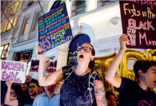  ?? AP ?? Protesters near the Trump Tower react as President Donald Trump arrives in New York. —