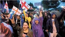  ?? Reuters-Yonhap ?? Demonstrat­ors hold a rally to protest against a bill in Tbilisi, Georgia, Saturday.