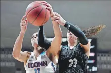  ?? JESSICA HILL/AP PHOTO ?? UConn’s Kia Nurse (11) and Saint Francis (Pa.)’s Jessica Kovatch fight for a rebound during the Huskies’ record-breaking 140-52 win in the opening round of the NCAA tournament on Saturday in Storrs.