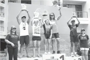  ?? PHOTO BY FID ACUÑA ?? Catherine “Kintoy” Acuña raises her first runner up trophy during the awarding ceremony of the Bellevue 5150 triathlon last weekend in Panglao, Bohol.