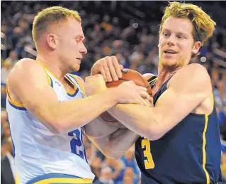  ?? MICHAEL OWEN BAKER/ASSOCIATED PRESS ?? UCLA guard Bryce Alford, left, and California’s Grant Mullins battle for the ball during the first half of the Bruins’ win Thursday in Los Angeles.