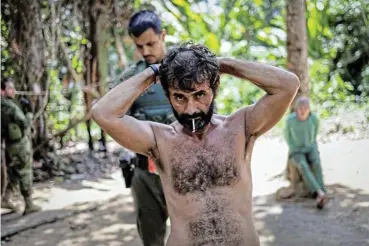  ?? /Reuters ?? Rounded up: Members of the special inspection group from the Brazilian Institute of Environmen­t and Renewable Natural Resources detain an illegal miner.