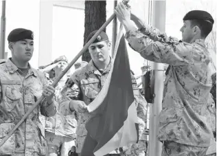  ?? MURRAY BREWSTER/ THE CANADIAN PRESS ?? From left, Master Cpl. Daniel Choong, Cpl. Harry Smiley and Cpl. Gavin Early take down the Canadian fl ag for the last time in Afghanista­n on Wednesday, marking the end of Canada’s 12- year mission in that country.