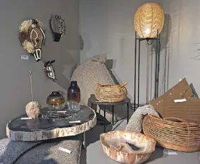  ??  ?? Raw: Ritual masks by Ethic and Tropic, fossilized stone table and bowls by Xyleia, amber glass vases by Pomax