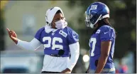  ?? John Munson / Associated Press ?? Saquon Barkley, left, who is on the physically unable to perform list, talks with fellow running back Gary Brightwell during the New York Giants’ training camp practice at Eddie Moraes Stadium in July in Newark, N.J.