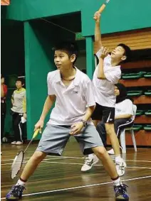  ??  ?? Play it cool: The boys’ Under-12 singles finalists Jun Hao (front) and Wei Ji forming the winning combinatio­n in the doubles.