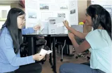  ?? JESSICA NYZNIK/EXAMINER ?? Yifei Zhou, left, and Shaylene Kathiravel­u, Grade 9 students at Kenner Collegiate, set up their sustainabl­e project display at Trent University during the launch of Peterborou­gh-Kawartha-Haliburton Regional Centre for Expertise on Friday.