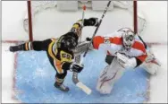  ?? GENE J. PUSKAR — THE ASSOCIATED PRESS ?? There’s no love lost between the Penguins and Flyers, as this crease confab between Pittsburgh forward Jake Guentzel and Flyers goalie Alex Lyon in a March 25 game attests.