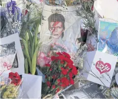  ?? REUTERS ?? Tributes to the late British singer David Bowie are seen at a makeshift memorial outside his home in the Manhattan borough of New York City on Wednesday.