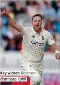  ??  ?? Key wicket: Robinson dismisses Kohli