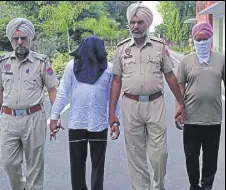  ?? HT PHOTO ?? Duni Chand and Ranjit Singh (faces covered) in police custody in Sangrur on Monday.
