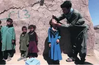  ?? Jalil Rezayee / EPA ?? A medical worker administer­s a polio vaccine to a child in the Enjil district of Herat, Afghanista­n, yesterday.