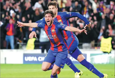  ?? EMILIO MORENATTI / AP ?? Barcelona’s Sergi Roberto celebrates scoring Barcelona’s sixth goal during Wednesday’s Champion League round of 16, second-leg match against Paris Saint Germain at Camp Nou stadium in Barcelona. The home side won 6-1 to advance to the quarterfin­als 6-5...