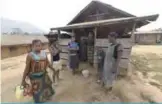  ??  ?? BASHU: Cameroonia­n refugees stand in front of their home in Bashu, Boki district of Cross Rivers State, southeast Nigeria. Nigeria has assured Cameroon that it is determined to deal with secessioni­st forces attempting to use its territory to...