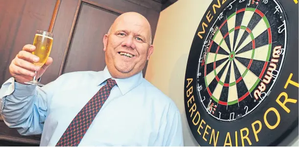  ??  ?? CHAIRMAN OF THE BOARD: Derek Weston, an organiser and men’s team manager for Grampian Darts Associatio­n, toasts what he is sure will be an action-packed event