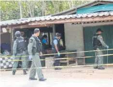  ??  ?? AFTERMATH: Members of the bomb squad cordon off the scene of the shooting where two people were killed in Yala late on Friday night.