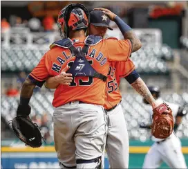  ?? GREGORY SHAMUS / GETTY IMAGES ?? Astros pitcher Doug White and catcher Martin Maldonado celebrate a 5-4 win over the Tigers on Wednesday at Comerica Park, completing a three-game sweep. The Astros have won 10 of their past 11 games.