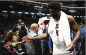  ?? NICK WASS — THE ASSOCIATED PRESS ?? Philadelph­ia 76ers center Joel Embiid greets fans after a game against the Washington Wizards on Wednesday.