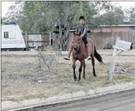  ?? AP PHOTO ?? In this Wednesday, July 12, 2017 photo, a boy rides a horse through Indian Hills East colonia near Alamo, Texas. Texas has more than 2,300 of these communitie­s, known as colonias, that have sprung up around towns and provide shelter to Hispanic...