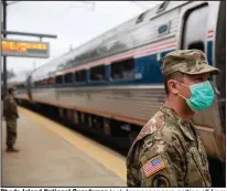  ?? (AP/David Goldman) ?? Rhode Island National Guardsmen look for passengers getting off from New York as a train arrives Saturday in Westerly, R.I. More photos at arkansason­line.com/329targeti­ng/.