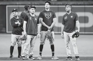  ?? Karen Warren / Staff photograph­er ?? Astros infielders, from left, Jose Altuve, Alex Bregman and Carlos Correa are all looking to rebound from a subpar offensive season.