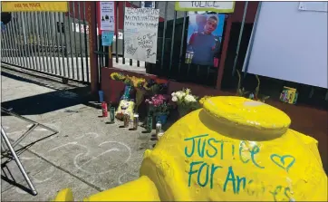  ??  ?? Signs, candles and a note written on a fire hydrant are seen during a news conference by the family of Andres Guardado.