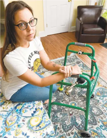  ?? RICK KINTZEL/THE MORNING CALL ?? Chelsea Cefalu sits next to her walker, named “Esmeralda,” on Tuesday at her Easton home. After contractin­g the virus, Cefalu had to use the walker to get around. Cefalu and many others are still experienci­ng COVID-19 symptoms after they have “recovered.”