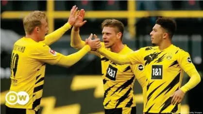  ??  ?? Borussia Dortmund celebrate a win that sends them back into the top four — at least until Sunday.